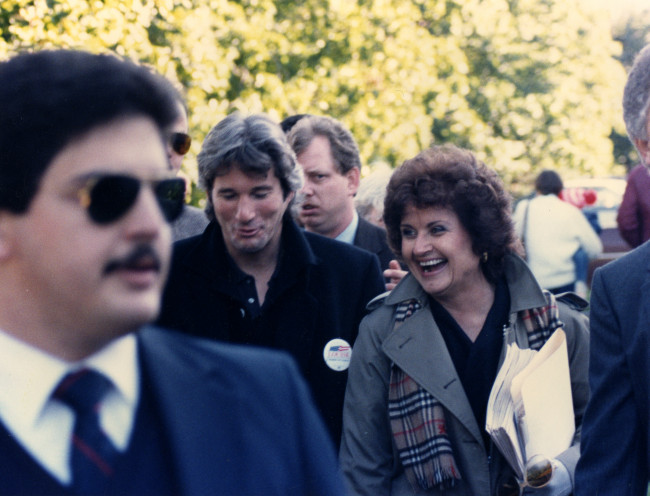 Congresswoman Louise Slaughter walking and laughing with Richard Gere