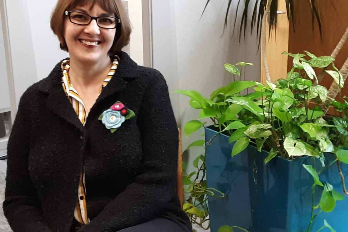 Moriana Garcia sitting next to a plant