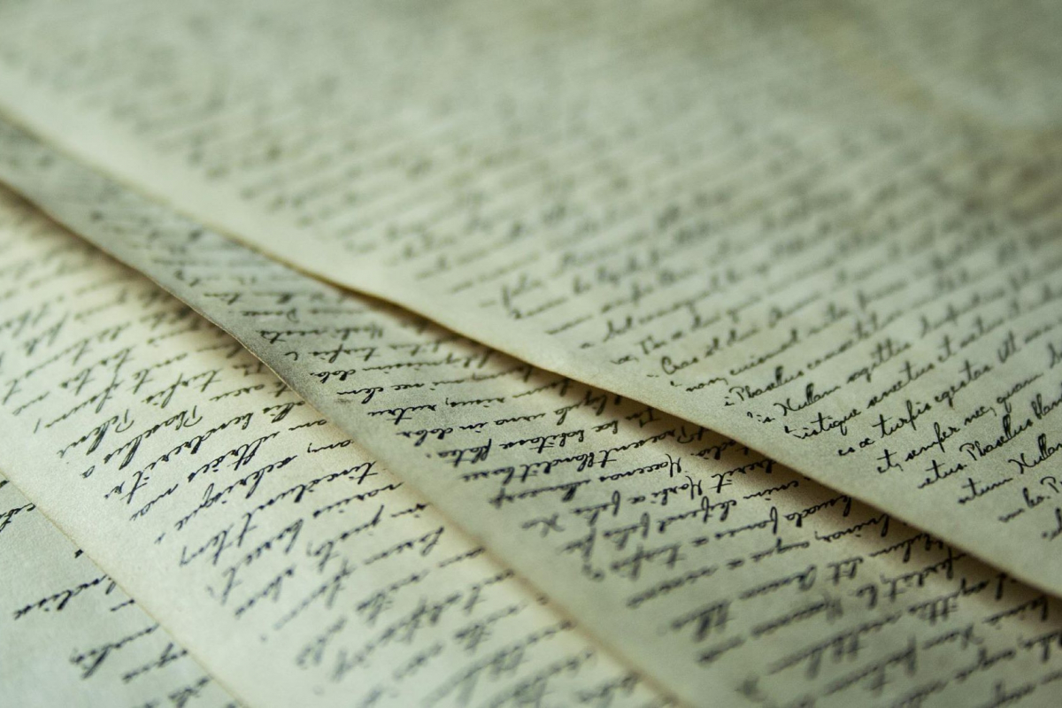 Old-looking pieces of paper that full of cursive writing