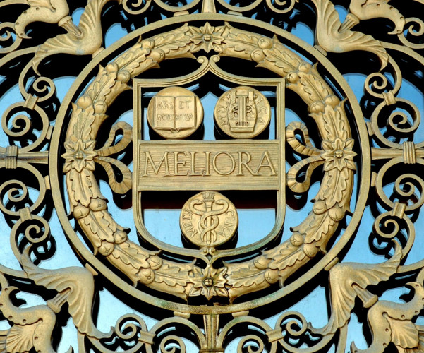 A gold representation of the University's shield from the entrance to Rush Rhees