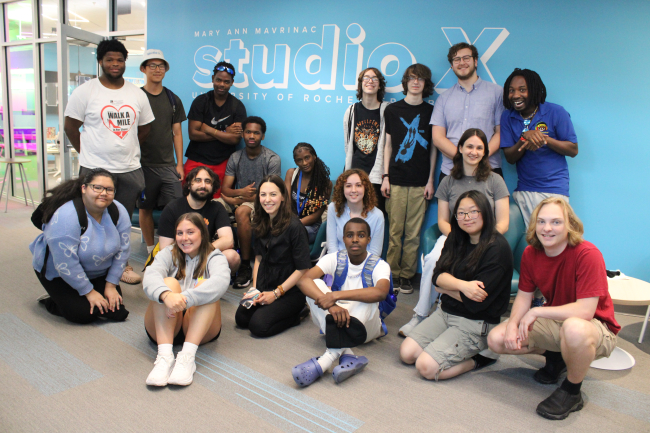 A group of people including staff and students posing for a group photo.