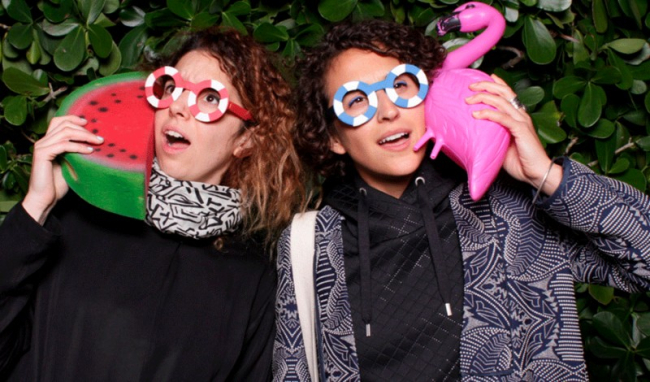 Speakers Ece Tankal and Carmen Aguilar y Wedge holding props and wearing funny glasses.