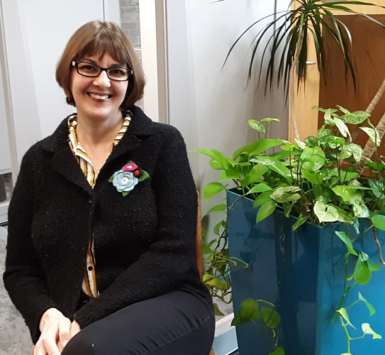 Moriana Garcia sitting next to a plant