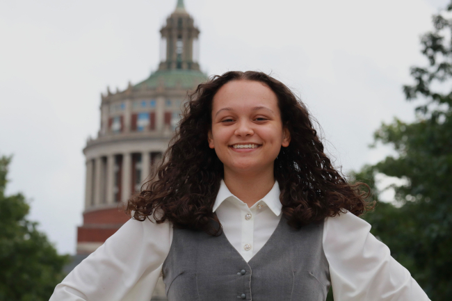 Author Ayiana Crabtree posing in front of Rush Rhees.