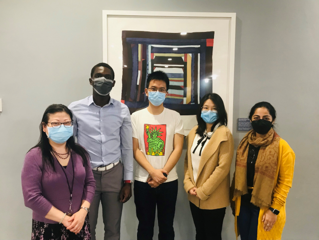 Librarians Kathy Wu and Sarah Siddiqui standing with data grant winners Jean-Joel Legre, Lipeng Chen, and Ruqui Wu in Lam Square