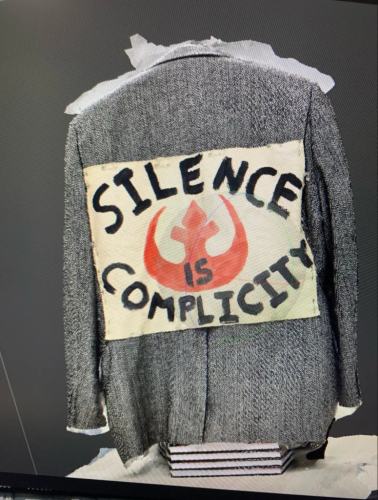 Col Raimond's digitized jacket. A patch on the back reads, "Silence is complicity."