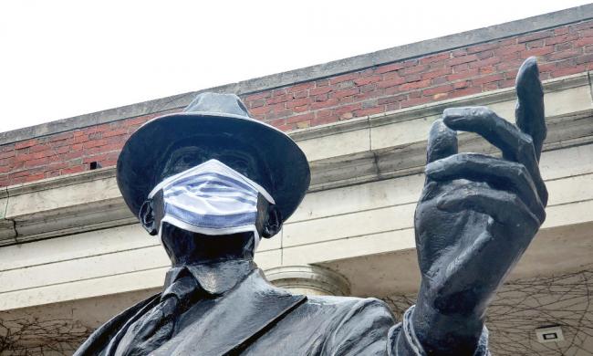 George Eastman statue wearing a COVID-19 mask