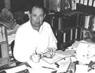 Rossell Hope Robbins at his desk