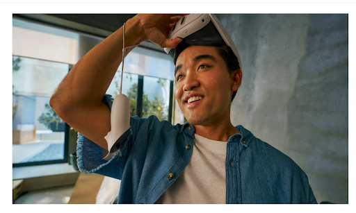 Person holding a virtual reality headset to their forehead looking amazed. 