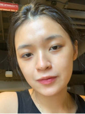 A person, Ha Nguyen, with black hair and black tank top stands in front of the camera